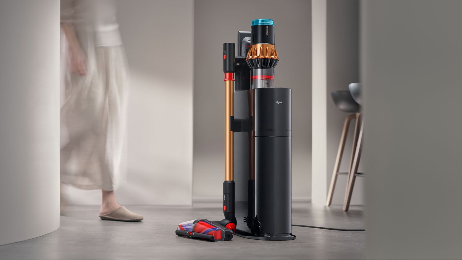 Dyson V16 Piston Animal vacuum on its Auto-empty Dok, exact Black/Copper package page